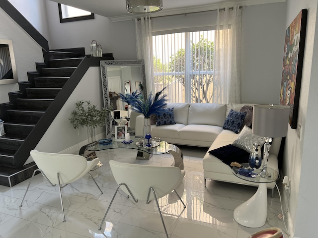 living area with marble finish floor and stairway