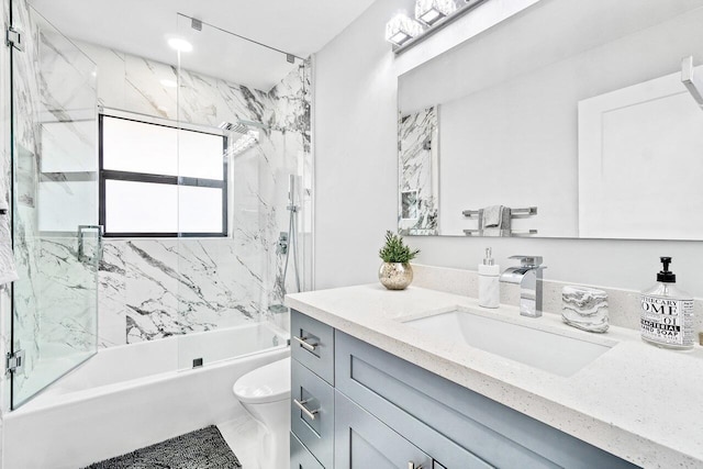 full bathroom with tiled shower / bath combo, toilet, and vanity