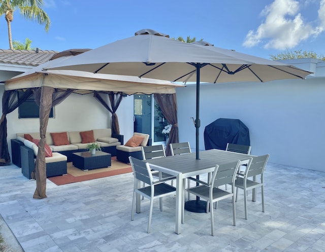 view of patio with an outdoor living space and a grill