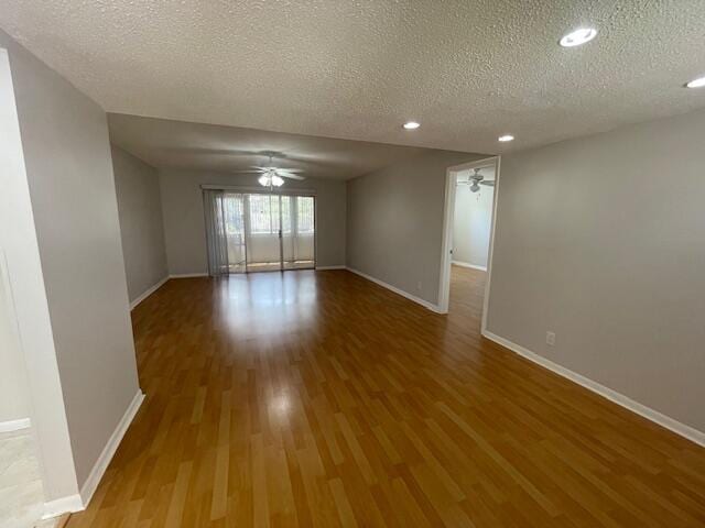 spare room with wood-type flooring, a textured ceiling, and ceiling fan