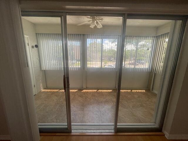 doorway to outside featuring hardwood / wood-style floors and ceiling fan