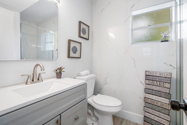 bathroom with vanity, toilet, an enclosed shower, and hardwood / wood-style flooring