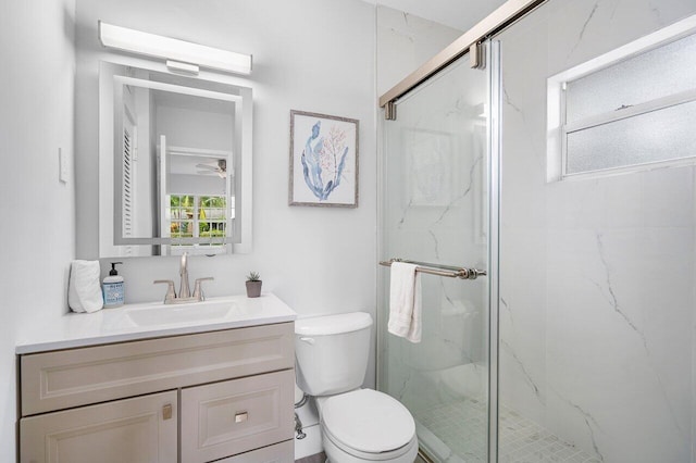 bathroom featuring vanity, toilet, and an enclosed shower