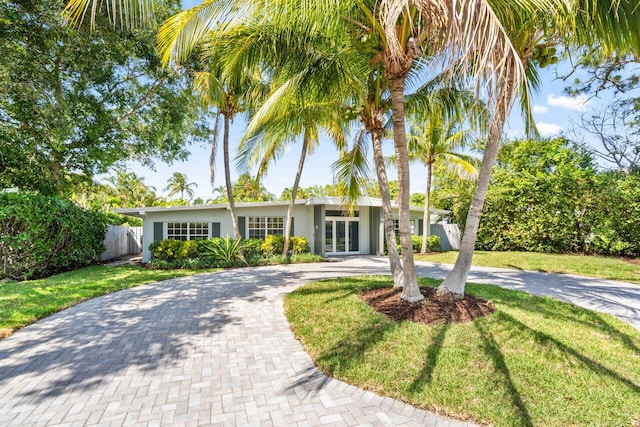 view of front of property with french doors and a front yard