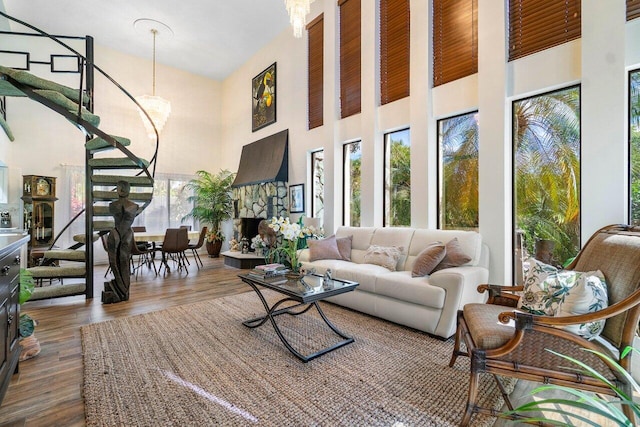 living room featuring a high ceiling, a fireplace, and dark hardwood / wood-style floors