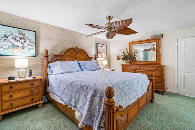 bedroom featuring a textured ceiling, ceiling fan, and carpet