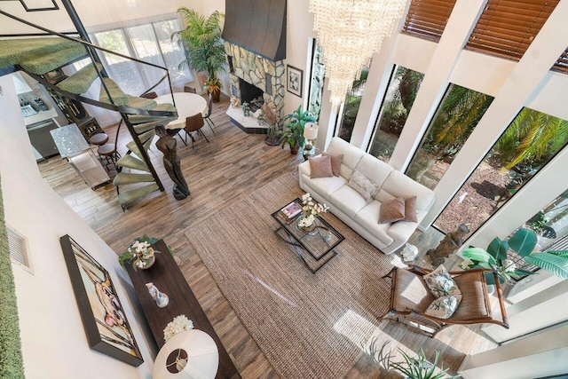 living room featuring a chandelier, hardwood / wood-style floors, and a fireplace