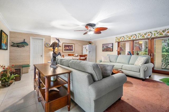 tiled living room featuring ornamental molding, ceiling fan, and a textured ceiling