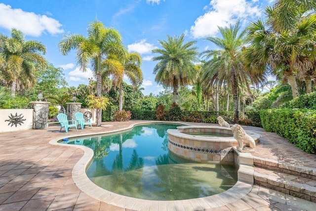 view of swimming pool with a patio area and an in ground hot tub