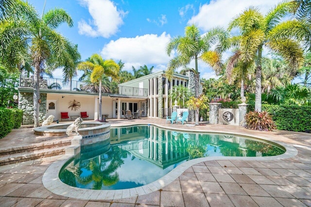 view of swimming pool with an in ground hot tub and a patio area