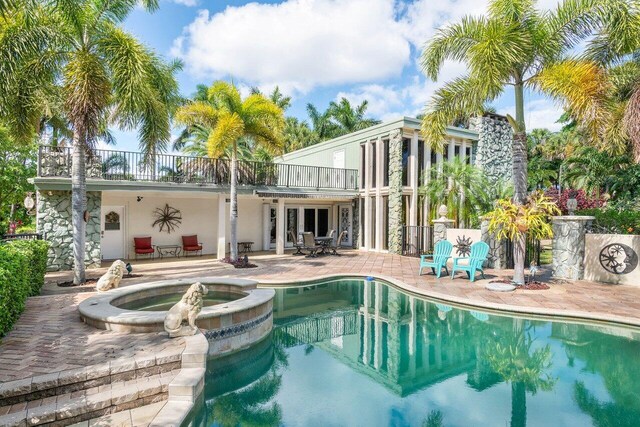 view of swimming pool with an in ground hot tub and a patio area