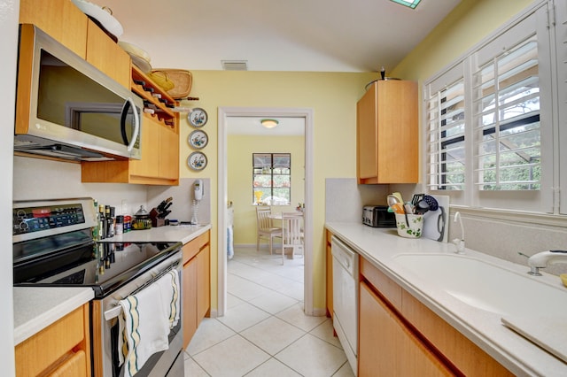 kitchen featuring appliances with stainless steel finishes and light tile floors