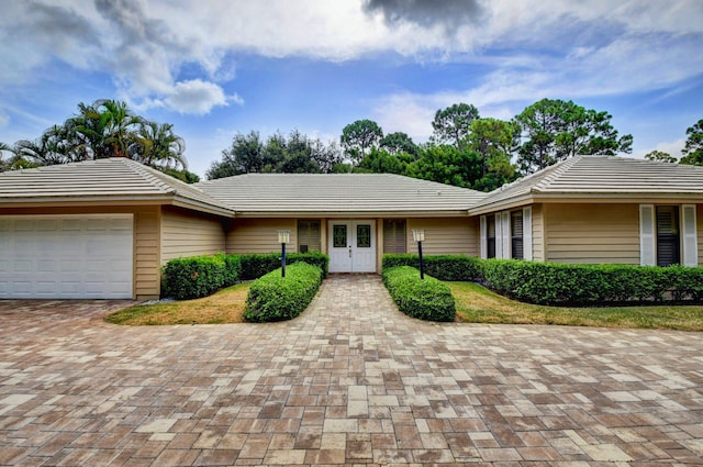 single story home with a garage