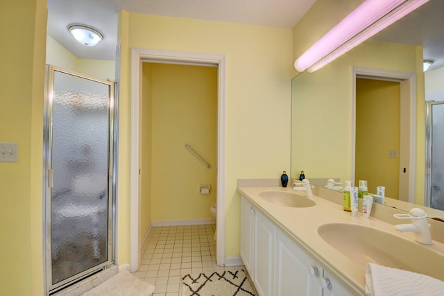 bathroom with dual bowl vanity, an enclosed shower, toilet, and tile floors