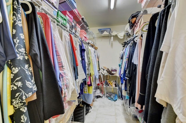 spacious closet featuring tile flooring