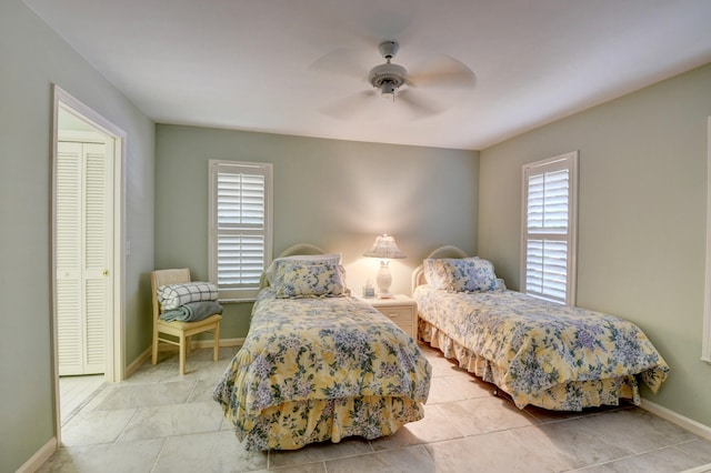 bedroom featuring a closet, ceiling fan, and tile floors