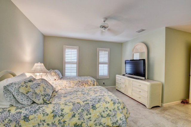 bedroom with ceiling fan and light tile floors