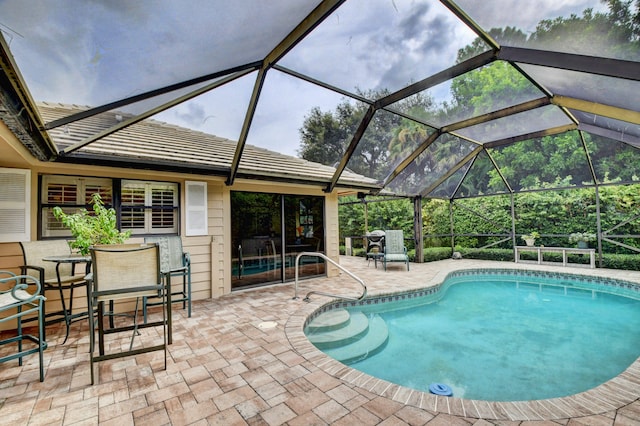 view of pool featuring a patio area and glass enclosure