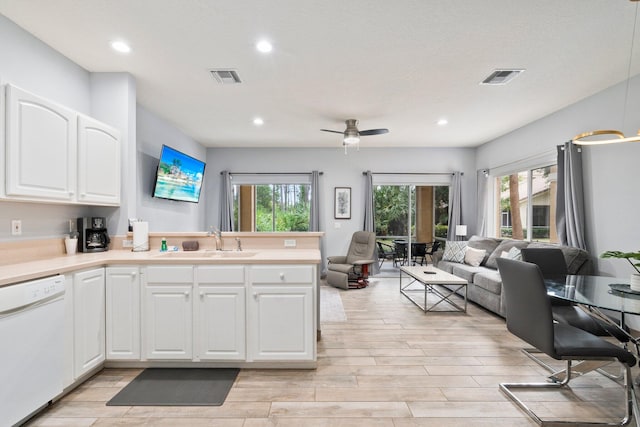 kitchen featuring white cabinets, light hardwood / wood-style flooring, sink, dishwasher, and ceiling fan