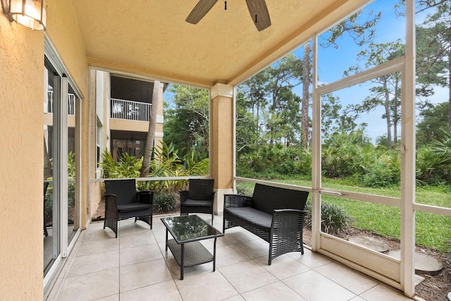 sunroom featuring a healthy amount of sunlight and ceiling fan