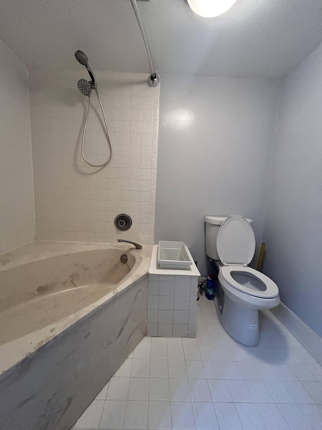 bathroom with tile floors, tiled shower / bath combo, toilet, and a textured ceiling