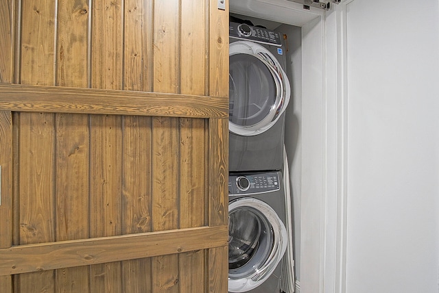 laundry area featuring stacked washer / drying machine