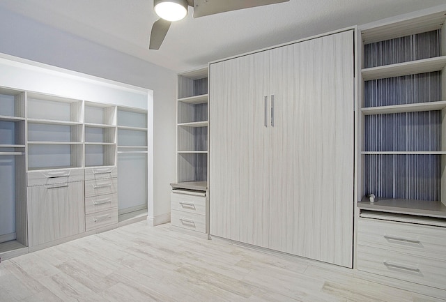 walk in closet featuring ceiling fan and light wood-type flooring