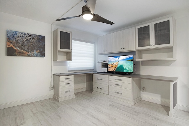 office area featuring ceiling fan, light hardwood / wood-style flooring, and built in desk