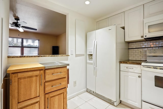 kitchen with white appliances, backsplash, light tile patterned floors, white cabinetry, and ceiling fan