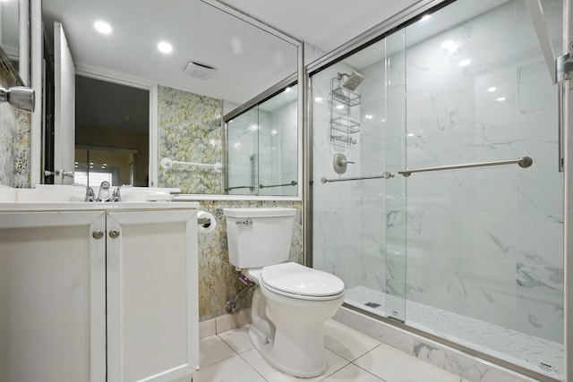 bathroom featuring a shower with shower door, vanity, toilet, and tile patterned floors