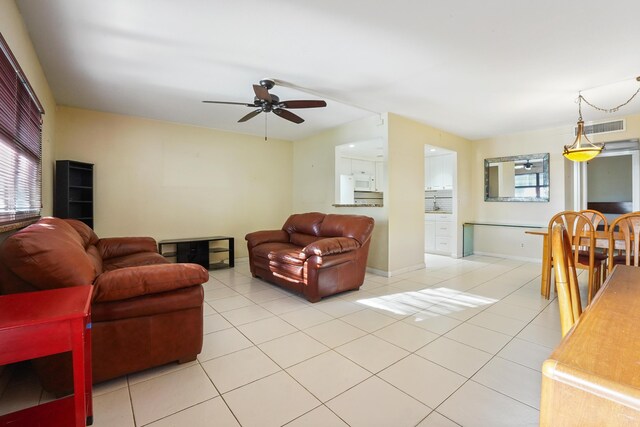 living room featuring ceiling fan and light tile patterned floors