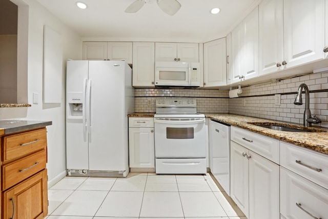 kitchen featuring light tile patterned flooring, sink, white appliances, and white cabinetry