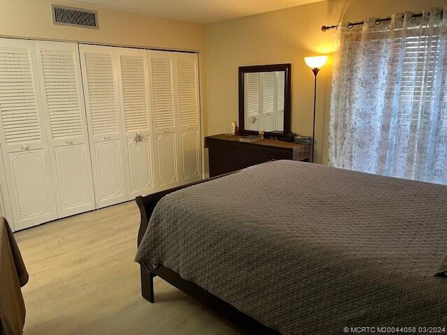 bedroom featuring a closet and light hardwood / wood-style floors