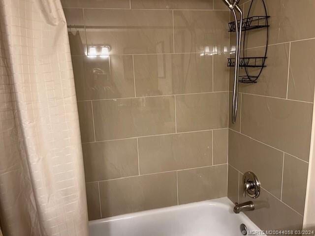 bathroom with shower / bathtub combination with curtain