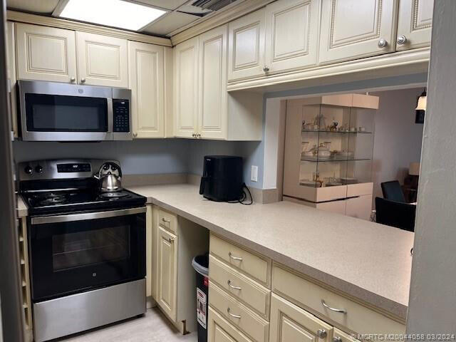 kitchen featuring cream cabinetry and stainless steel appliances