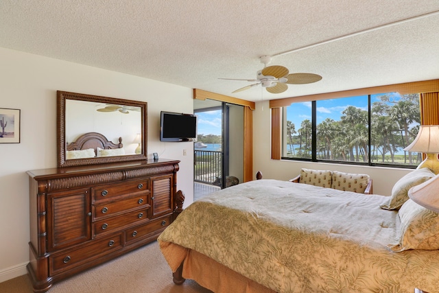 carpeted bedroom featuring a textured ceiling, access to outside, multiple windows, and ceiling fan