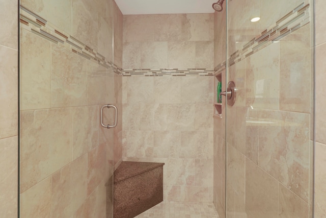 bathroom with a shower with door