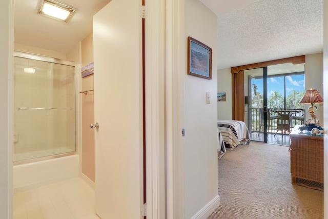 interior space with a textured ceiling, expansive windows, and light carpet