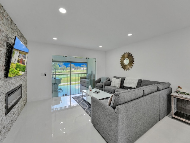 living room featuring a stone fireplace