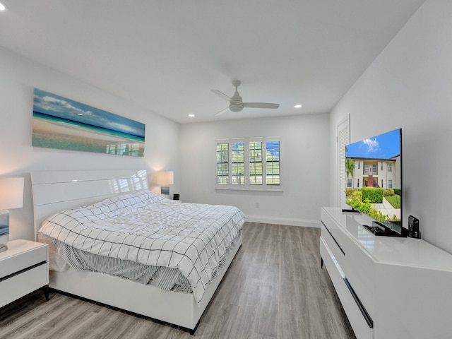 bedroom with light wood-type flooring and ceiling fan