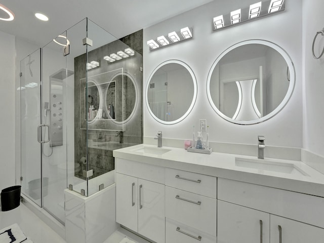 bathroom with vanity and a shower with door