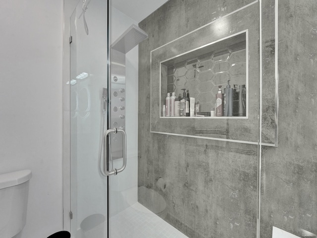 bathroom with an enclosed shower and toilet