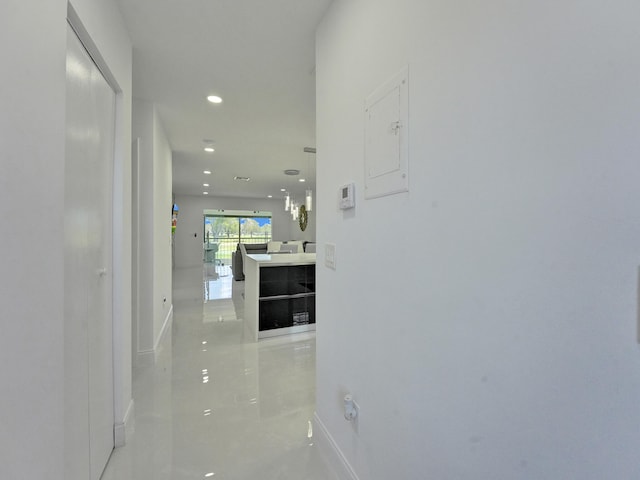 corridor featuring electric panel and light tile patterned flooring