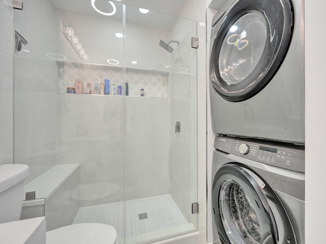 washroom featuring stacked washer and clothes dryer