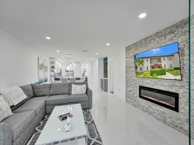 living room featuring a stone fireplace