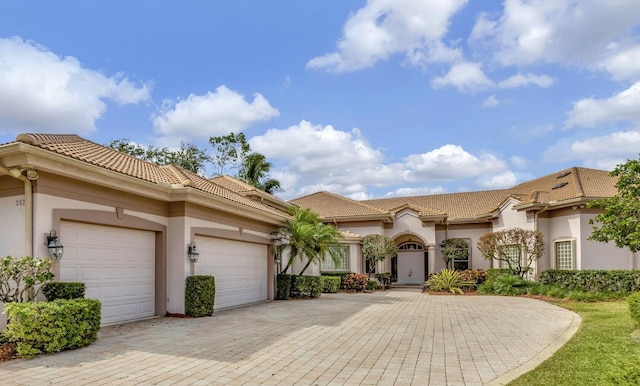 mediterranean / spanish home with a garage