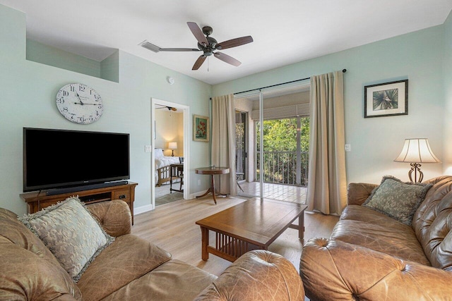 living room with ceiling fan and light hardwood / wood-style flooring