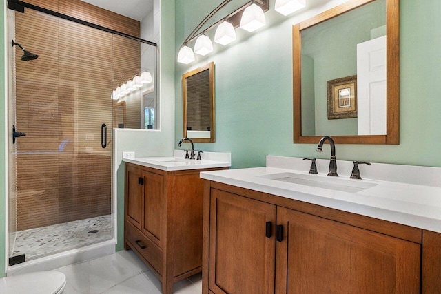 bathroom featuring vanity, toilet, tile patterned floors, and a shower with door