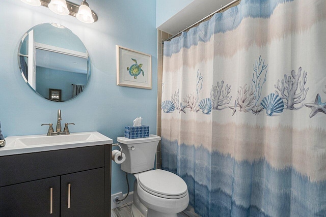 bathroom featuring a shower with curtain, vanity, and toilet