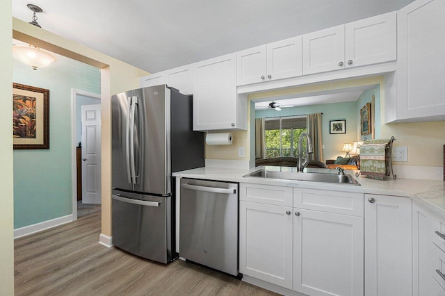 kitchen featuring appliances with stainless steel finishes, sink, and white cabinets